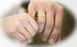 Two hands wear wedding rings.